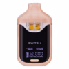 Boutiq Switch V4 2G dual-chamber vape pen displaying Purple Peeps and Orange Tic Tacs cannabis oil, with digital screen and 'SWITCH' button, on a clean white background.